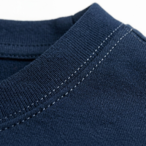 Close-up of shoulder stitching and high-quality cotton fabric texture