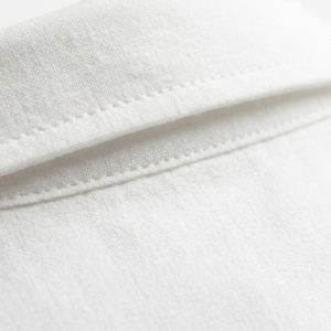 Close-up detail of reinforced stitching and brass hardware on leather tote